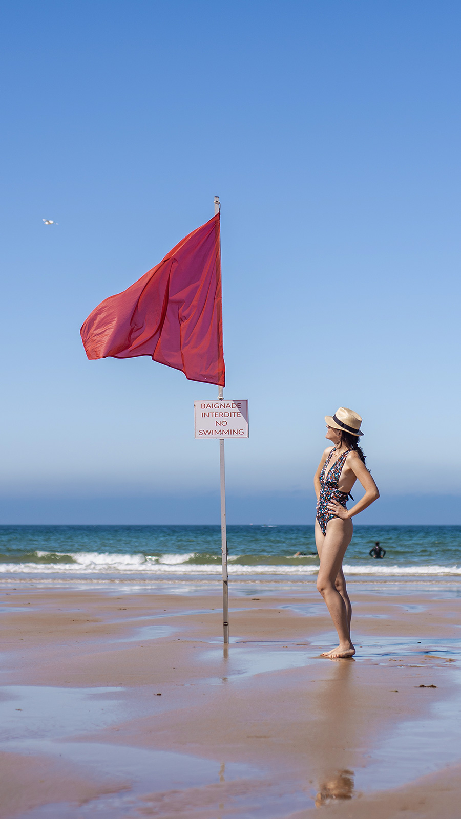 blue atelier eco swimming suits brand photo with red flag by lorenna martin